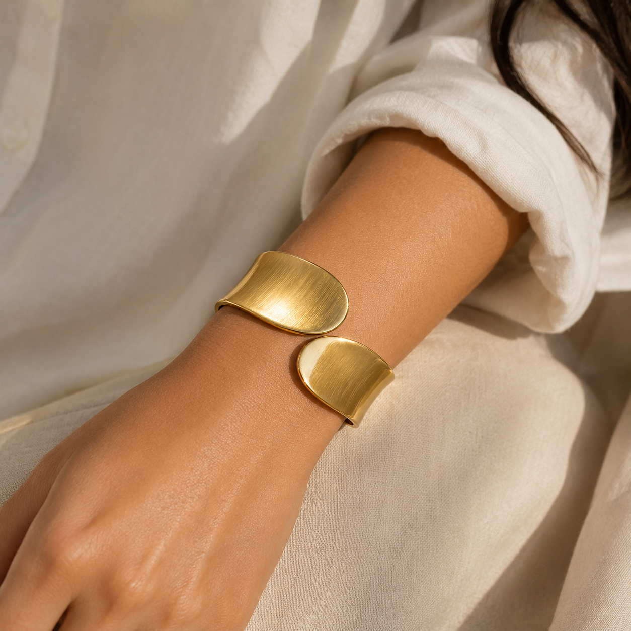 Gold cuff bracelet on wrist